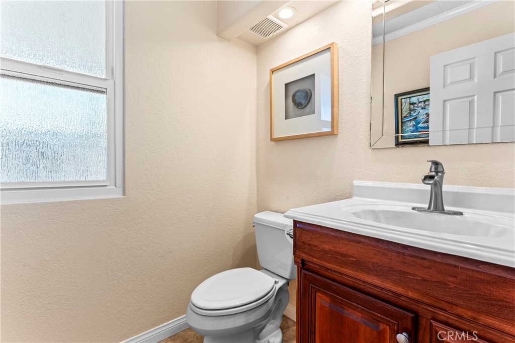 5737 Peridot Avenue Rancho Cucamonga, CA 91701 - Photo 34 of 40 a bathroom with a toilet a sink and mirror