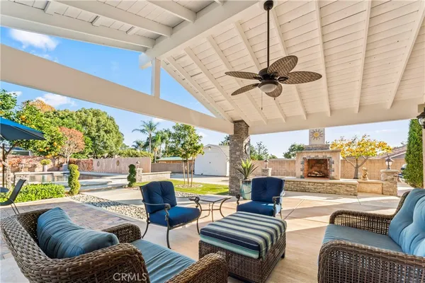 a living room with patio furniture and a floor to ceiling window