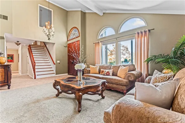 a view of a dining room with furniture and chandelier