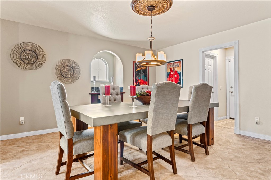5737 Peridot Avenue Rancho Cucamonga, CA 91701 - Photo 10 of 40 a view of a dining room with furniture and chandelier