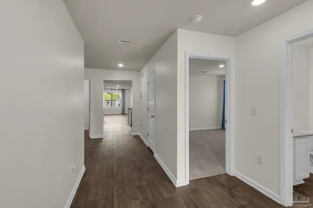 a view of hallway with wooden floor