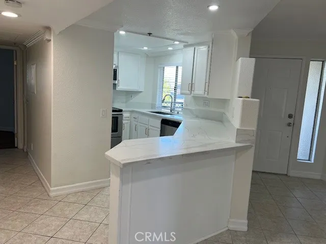 a kitchen with stainless steel appliances a refrigerator and microwave