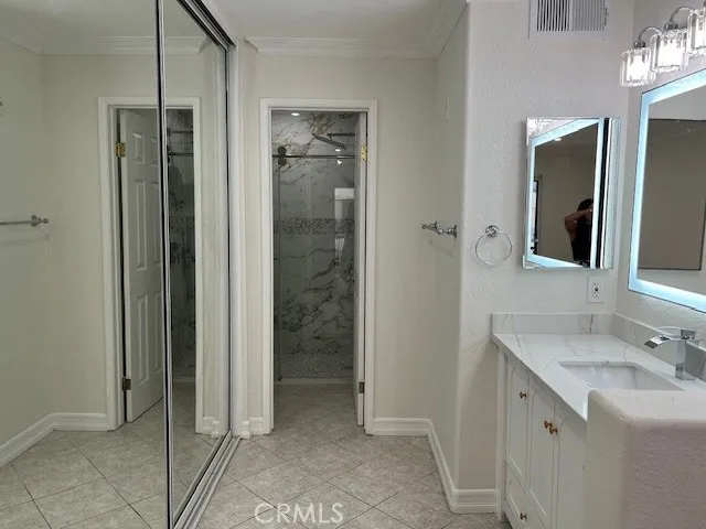 a bathroom with a shower a sink and a mirror