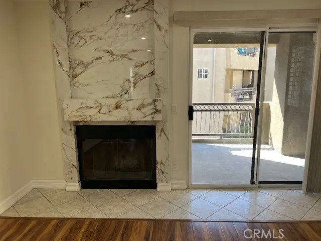 a view of fireplace in hallway with wooden floor