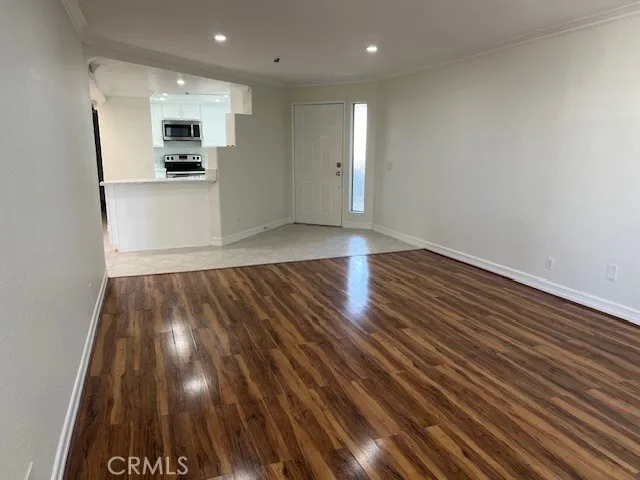 a view of kitchen space with wooden floor and electronic appliances
