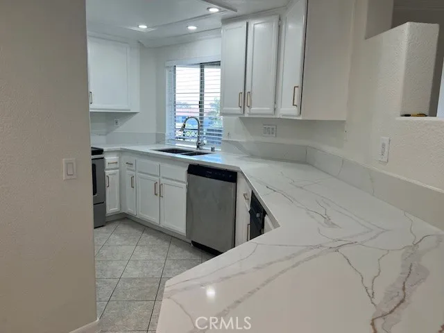 a kitchen with stainless steel appliances granite countertop a sink and a stove