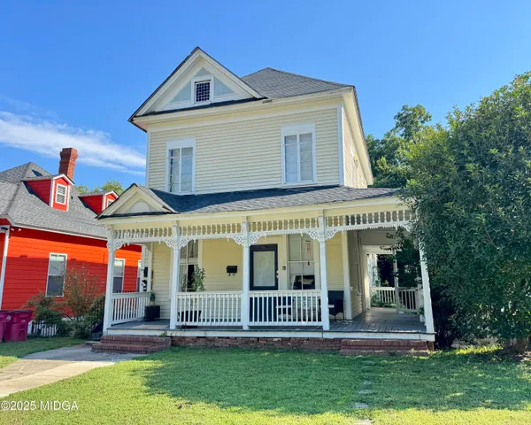 a front view of house with yard and green space
