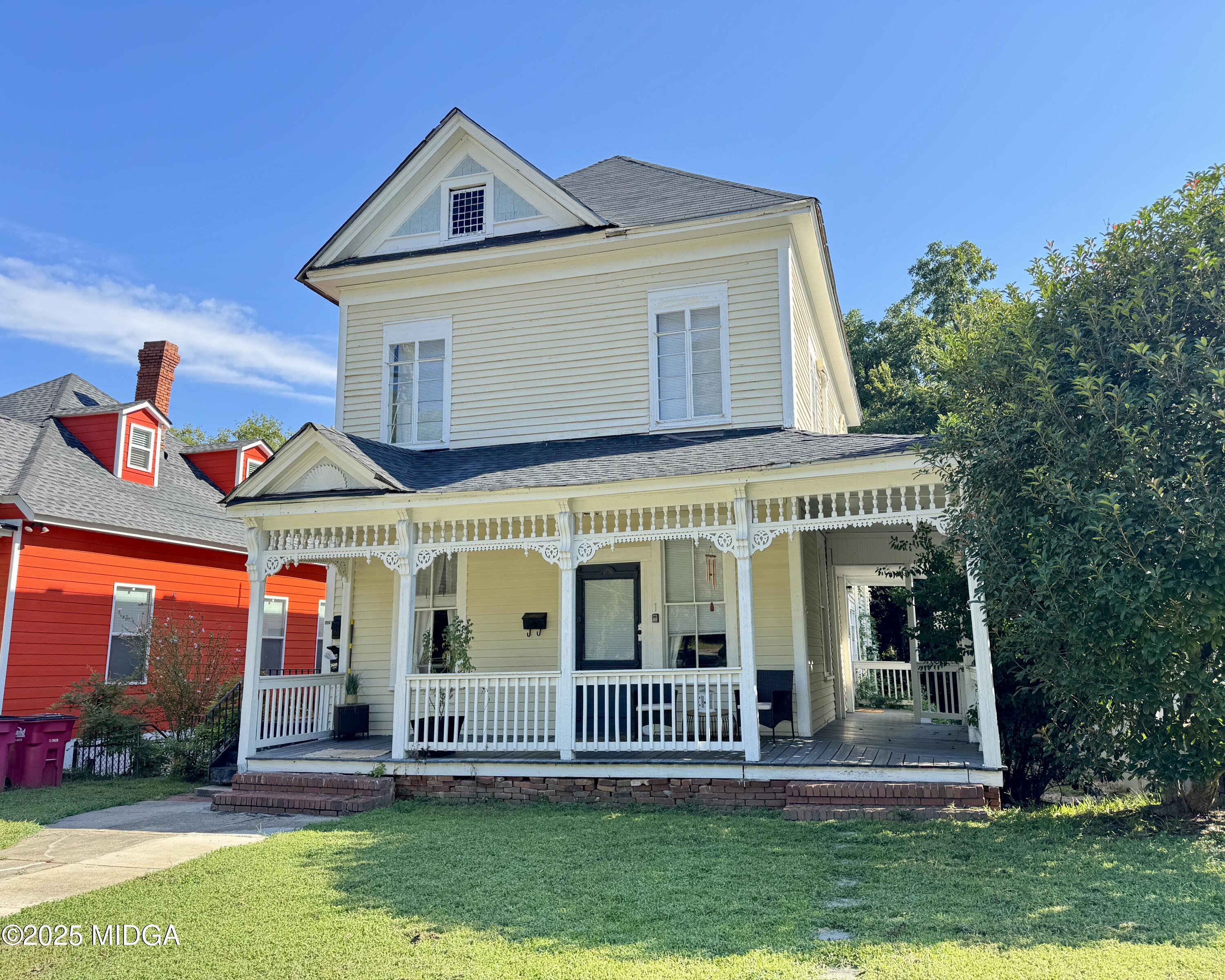 a front view of house with yard and green space