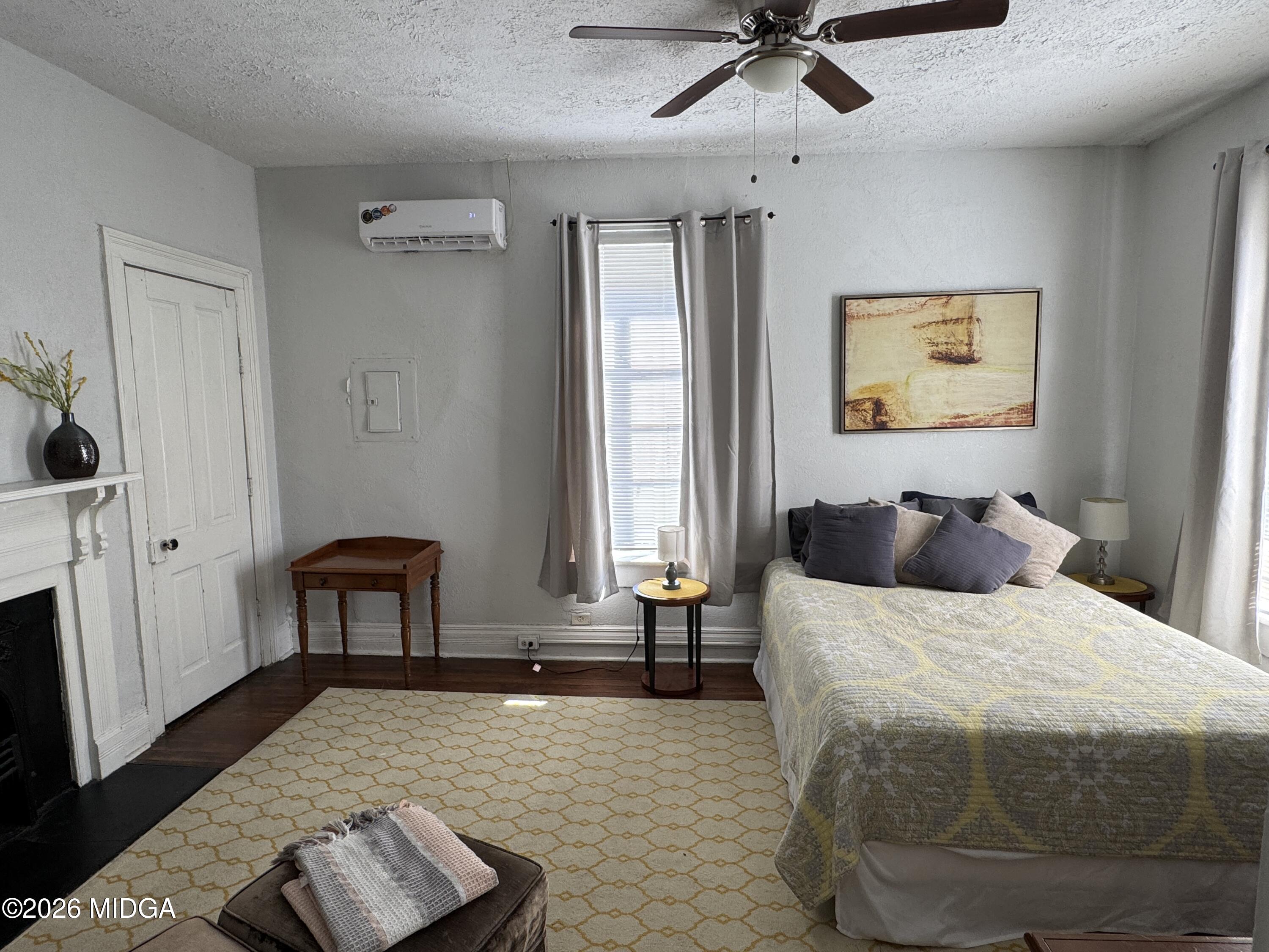 1687 Lawton Avenue Macon, GA 31201 - Photo 17 of 22 a bedroom with a bed and a chandelier