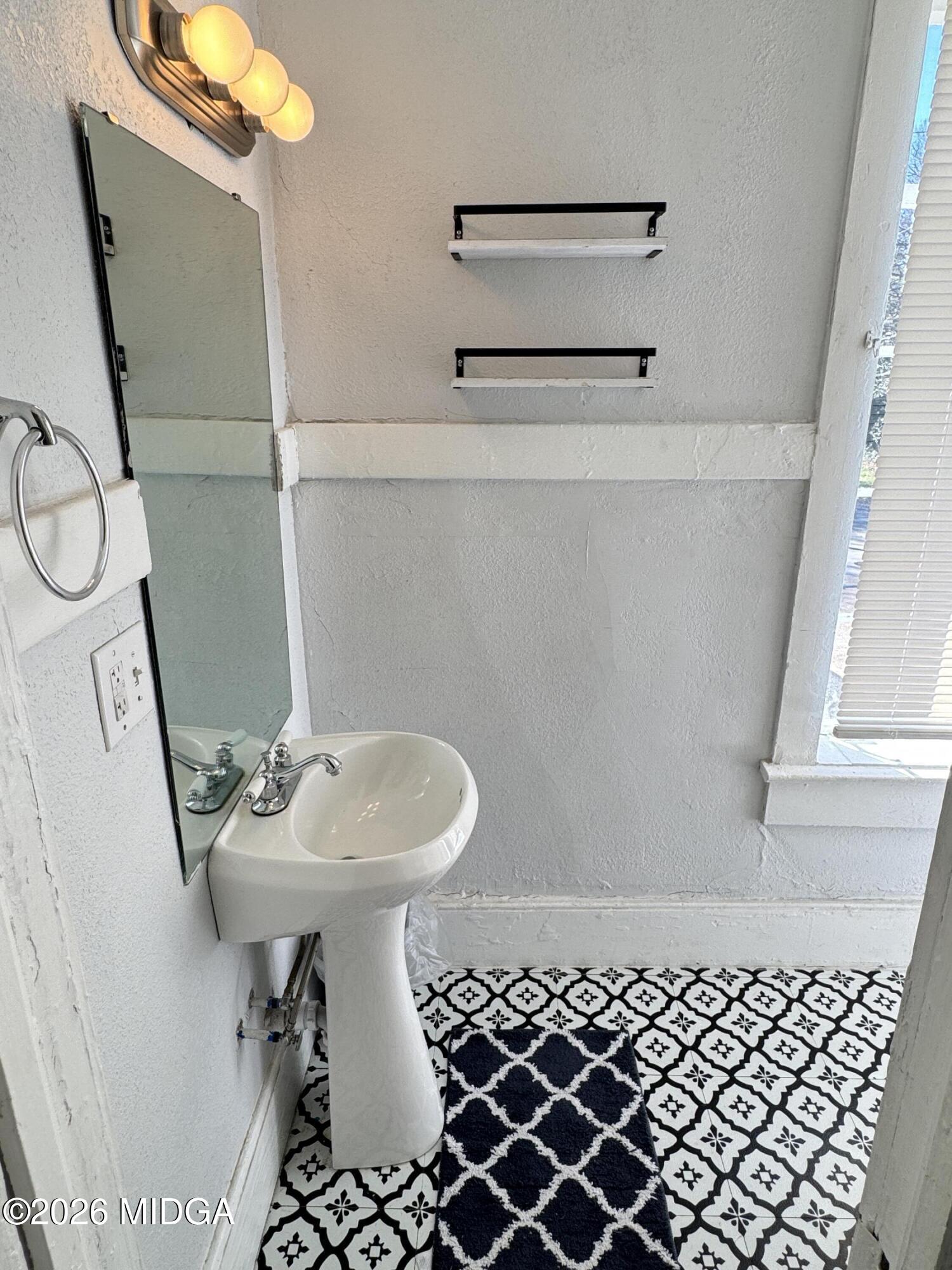 1687 Lawton Avenue Macon, GA 31201 - Photo 18 of 22 a bathroom with a sink toilet and shower