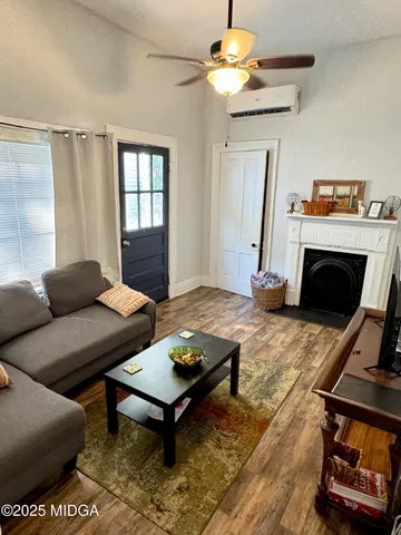 a living room with furniture a fireplace and a table