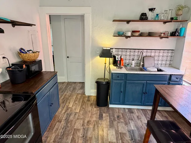 a kitchen with sink cabinets and stove