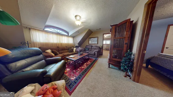 a bed room with a bed and a refrigerator
