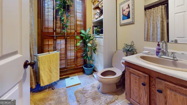 a bedroom with a bed and a dresser next to a window