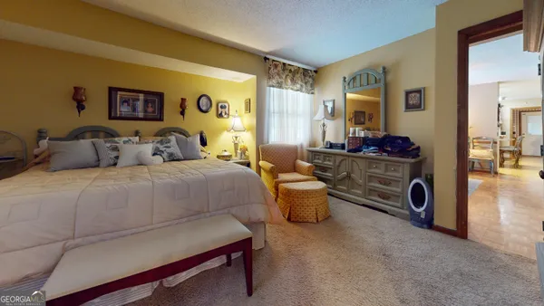 a kitchen with a sink a table and chairs in it
