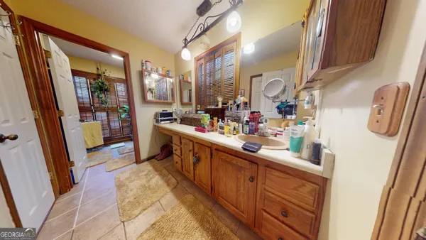 a bathroom with a sink mirror vanity and toilet