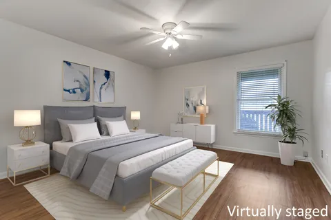 a spacious bedroom with a large bed and a chandelier