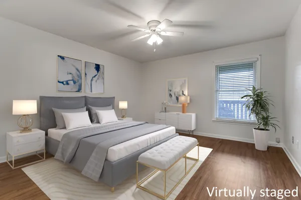 a spacious bedroom with a large bed and a chandelier