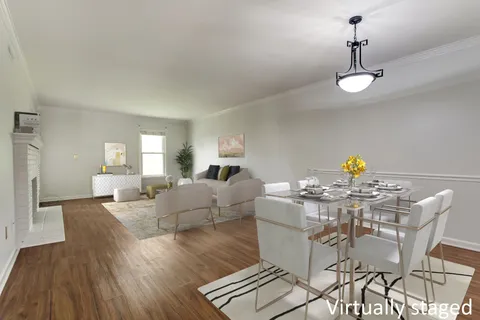 a view of a dining room with furniture wooden floor and chandelier