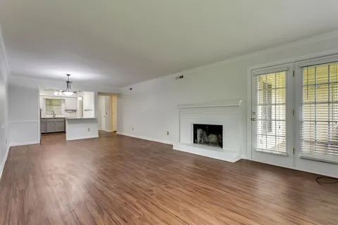 a view of a room wooden floor and a kitchen