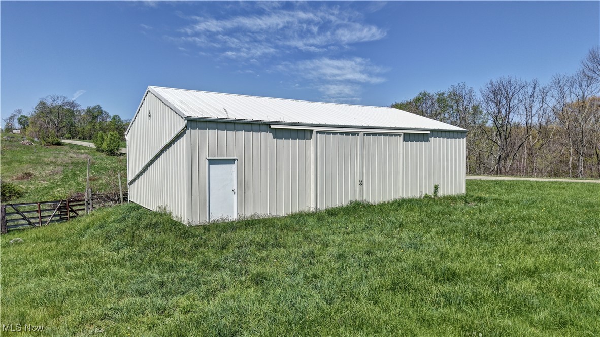 7166 Clay Pike Road Cambridge, OH 43725 - Photo 24 of 27 View of pole building with fence and a yard