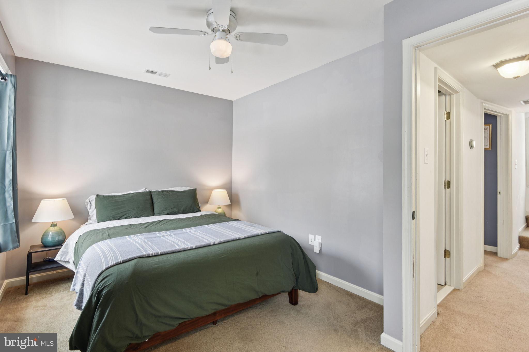 14844 Toll Road New Windsor, MD 21776 - Photo 18 of 30 a bedroom with a bed and a chandelier