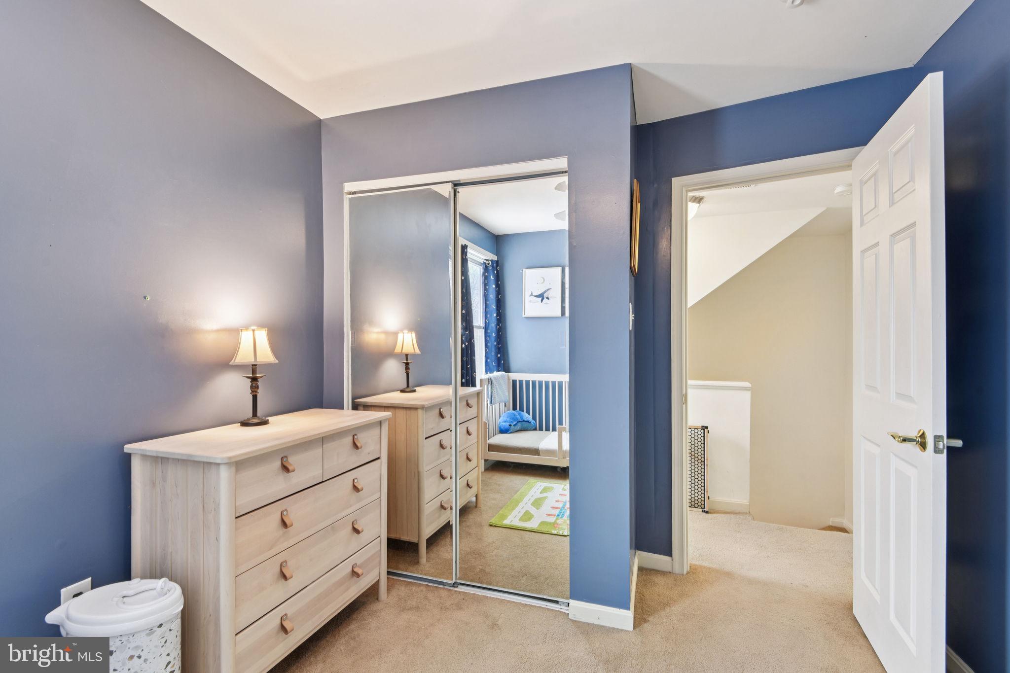 14844 Toll Road New Windsor, MD 21776 - Photo 22 of 30 a room with a baby bed mirror and a lamp