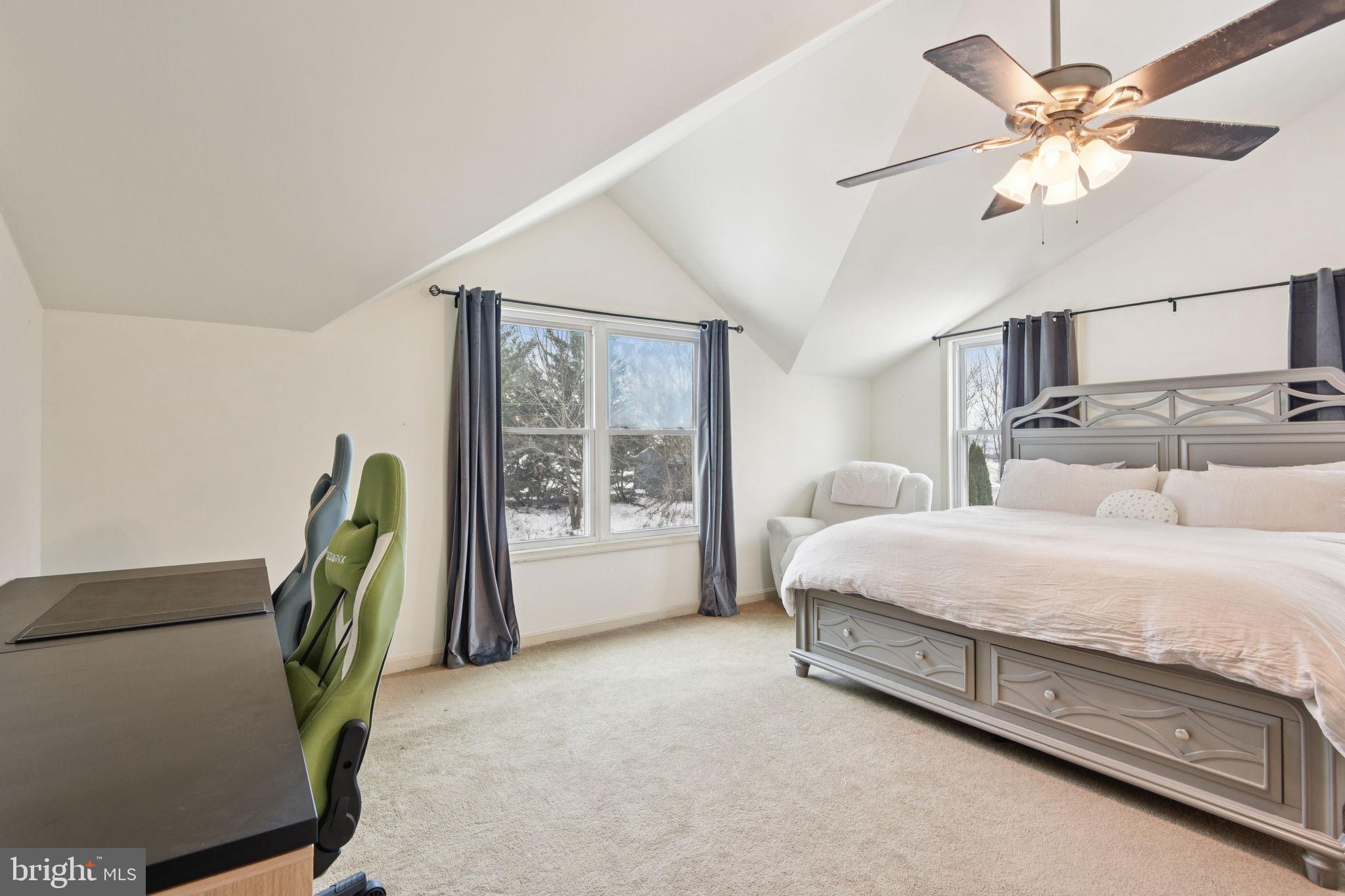 14844 Toll Road New Windsor, MD 21776 - Photo 24 of 30 a spacious bedroom with a bed a chandelier and a bookshelf with wooden floor