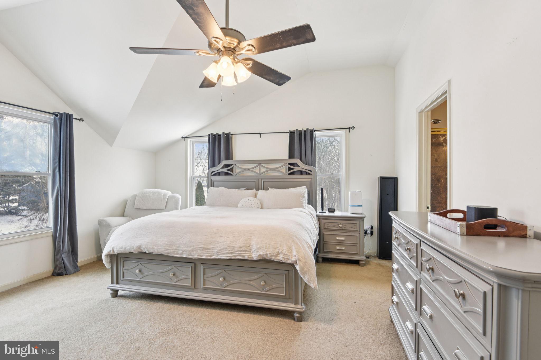 14844 Toll Road New Windsor, MD 21776 - Photo 25 of 30 a spacious bedroom with a bed a window and a chandelier