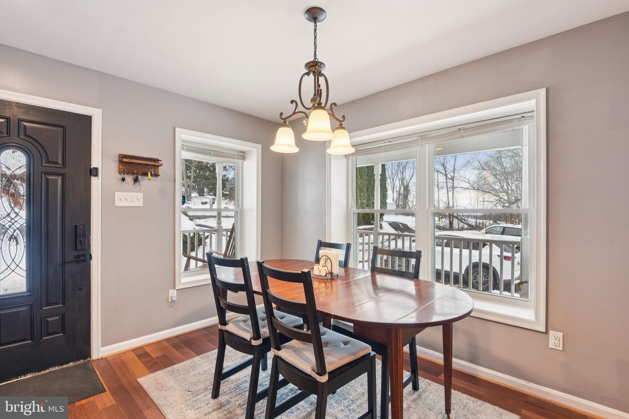 14844 Toll Road New Windsor, MD 21776 - Photo 10 of 30 a dining room with furniture a chandelier and wooden floor