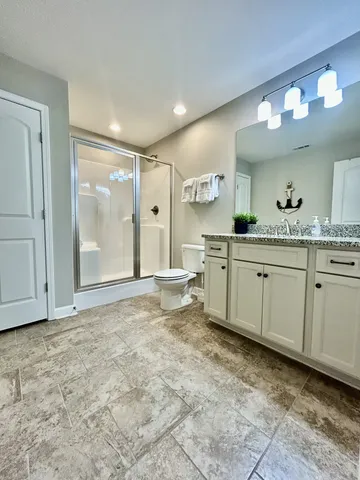 a large bathroom with a sink a mirror and a bathtub