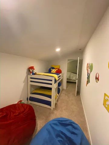 a bedroom with a bed and a dresser