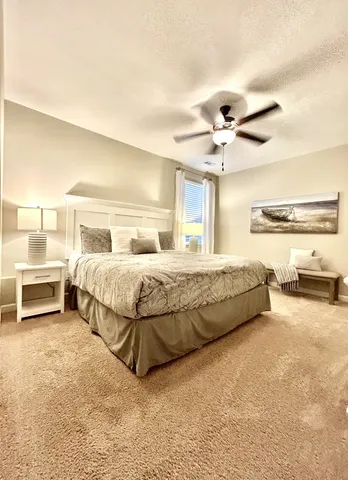 a bedroom with a bed and ceiling fan