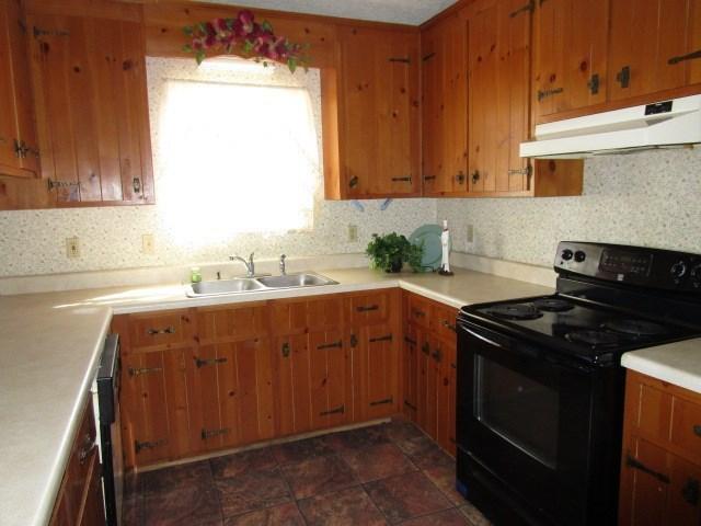 2704 The Great Road Fieldale, VA 24089 - Photo 6 of 14 a kitchen with a sink stove top oven and cabinets