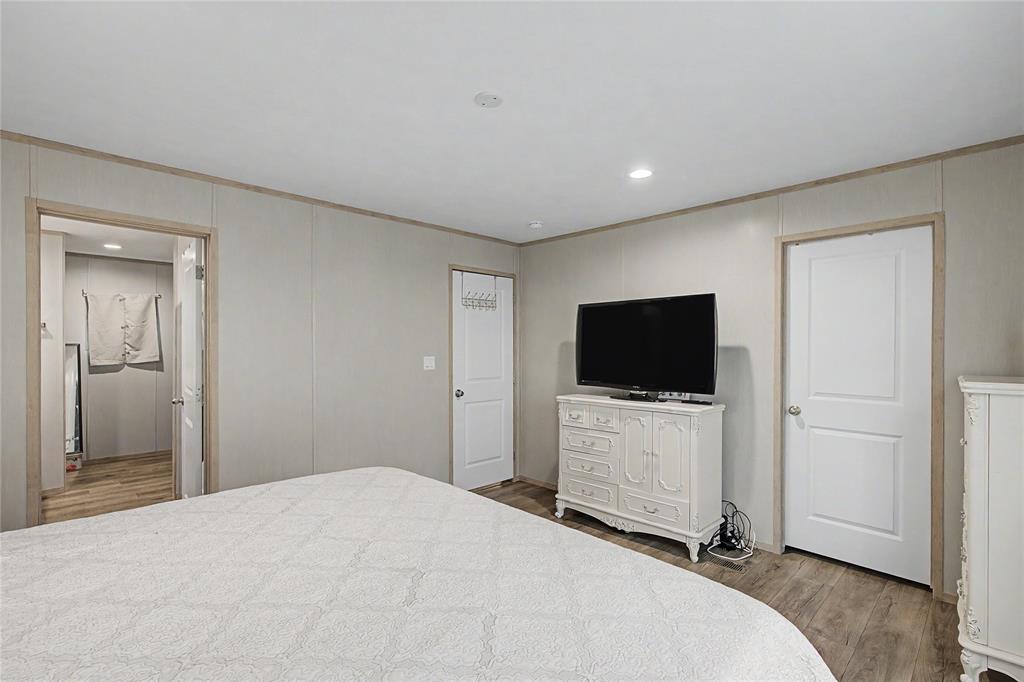 6065 Timber Trail Azle, TX 76020 - Photo 16 of 33 a bedroom with a bed and a flat screen tv