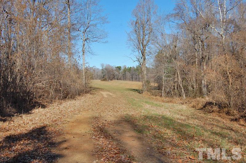 3747 Old Allensville Road Roxboro, NC 27574 - Photo 44 of 45 a view of dirt field with trees in the background