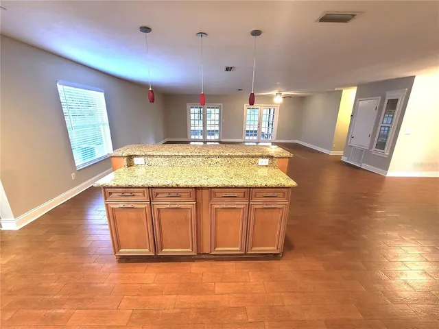 a bathroom with a granite countertop sink and a large mirror