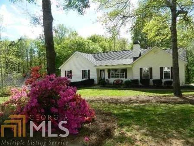 115 Riverside Court Sharpsburg, GA 30277 - Photo 1 of 1 a front view of a house with a yard and garage