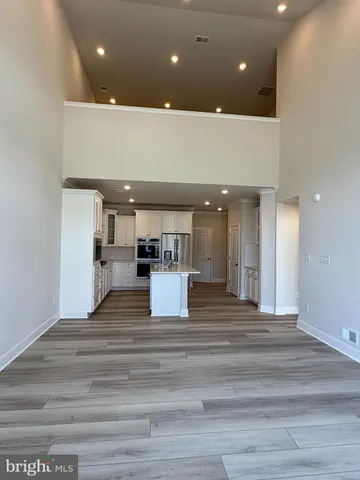 a view of a kitchen with a sink and a refrigerator