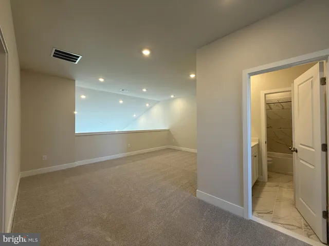 a bathroom with a white bath tub and a shower