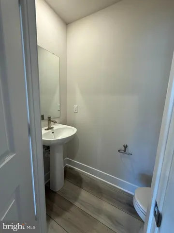 a bathroom with sink shower and toilet