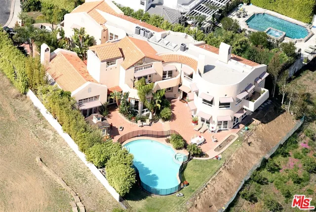 an aerial view of a house with a swimming pool