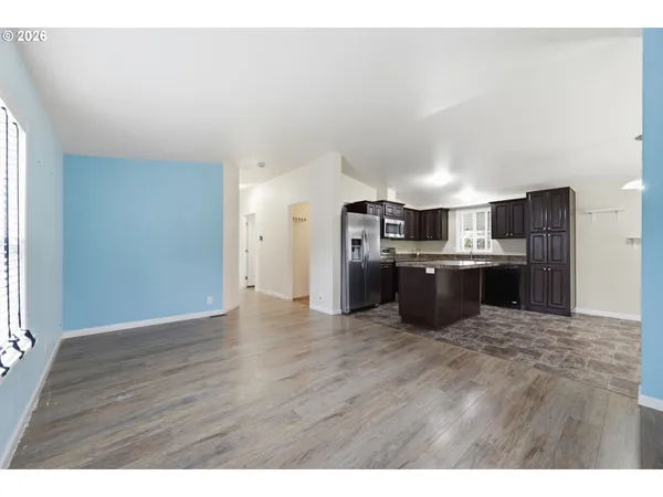 a kitchen with stainless steel appliances granite countertop a stove top oven a sink dishwasher and a refrigerator