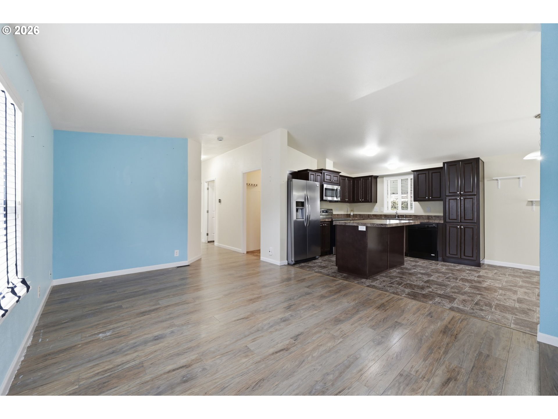 1475 Green Acres Road, Unit 150 Eugene, OR 97408 - Photo 11 of 34 a kitchen with stainless steel appliances granite countertop a stove top oven a sink dishwasher and a refrigerator