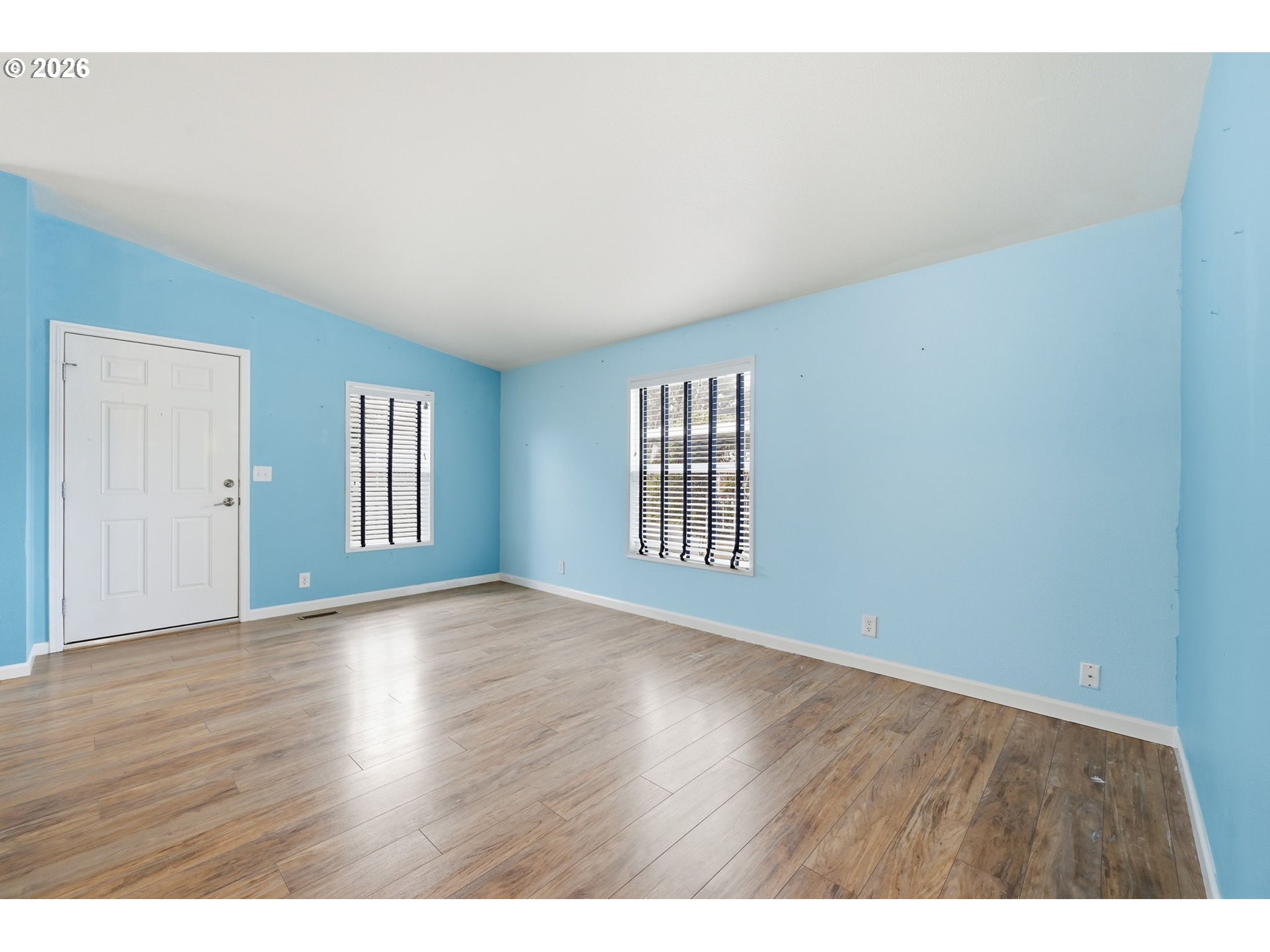 1475 Green Acres Road, Unit 150 Eugene, OR 97408 - Photo 13 of 34 a view of an empty room with wooden floor and windows