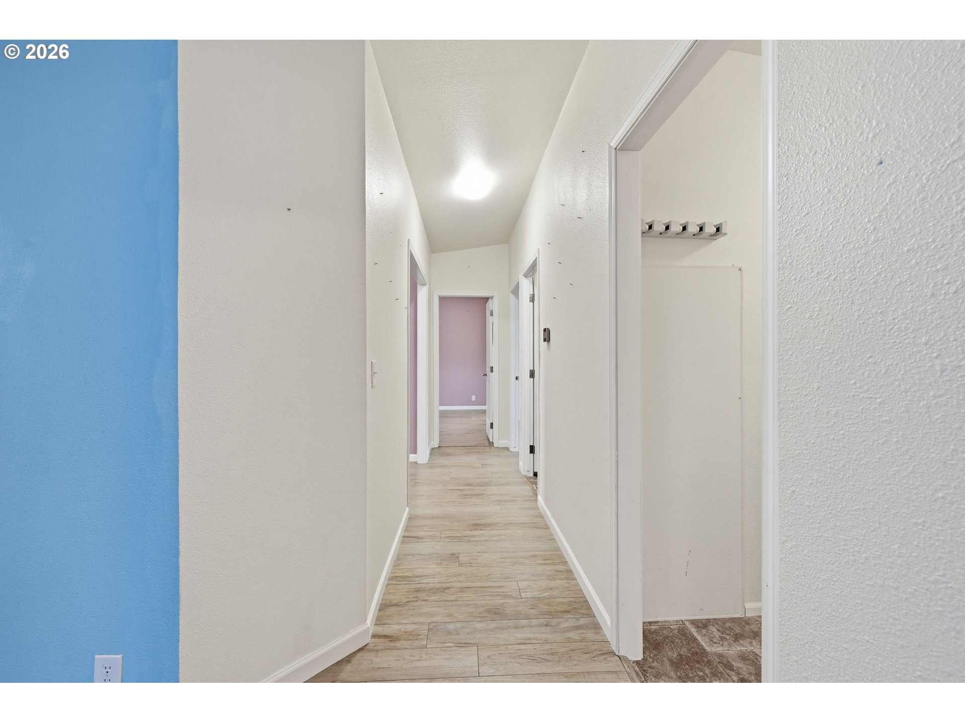 1475 Green Acres Road, Unit 150 Eugene, OR 97408 - Photo 14 of 34 a view of a hallway with wooden floor
