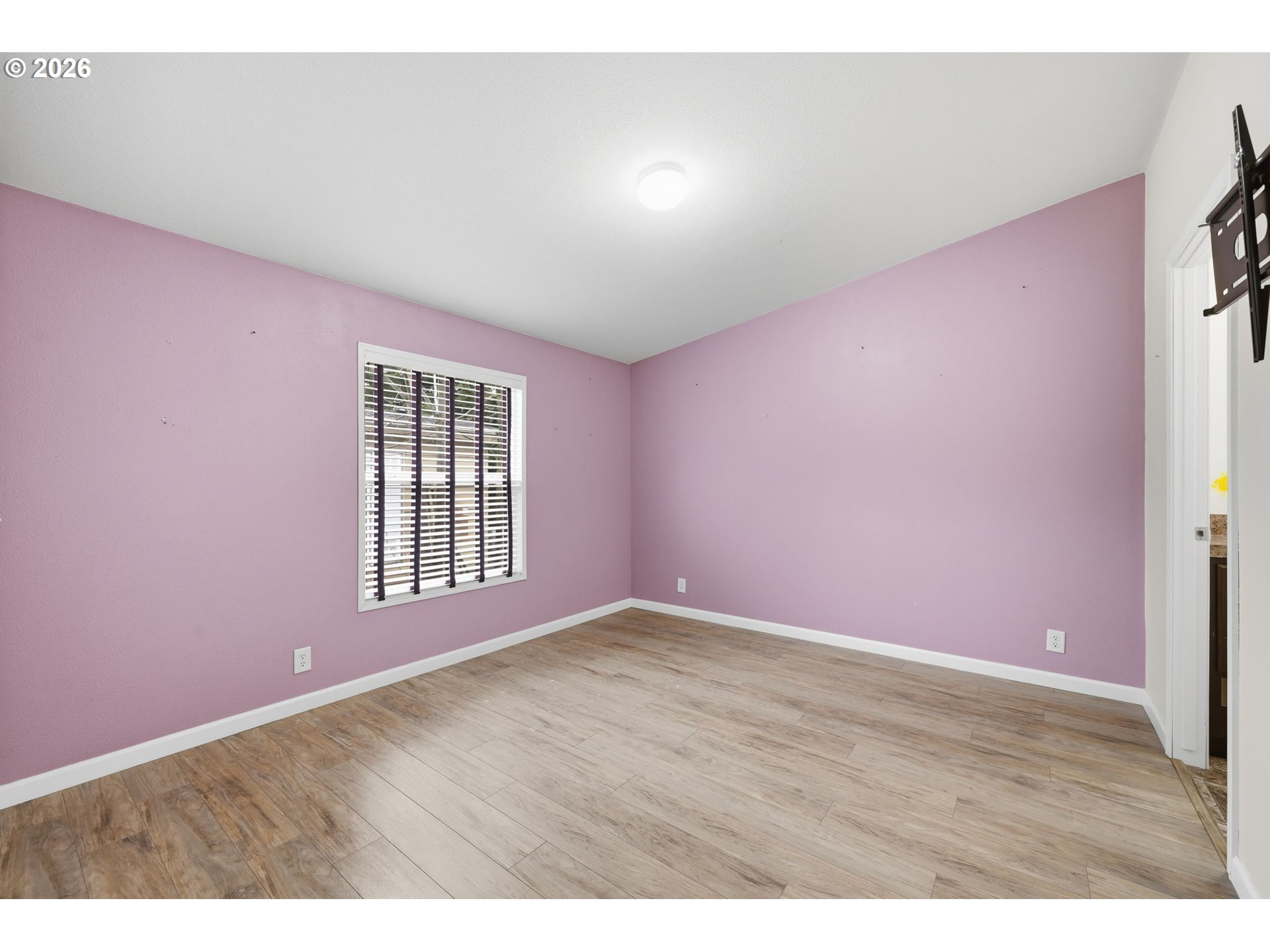 1475 Green Acres Road, Unit 150 Eugene, OR 97408 - Photo 16 of 34 a view of an empty room with wooden floor and a window