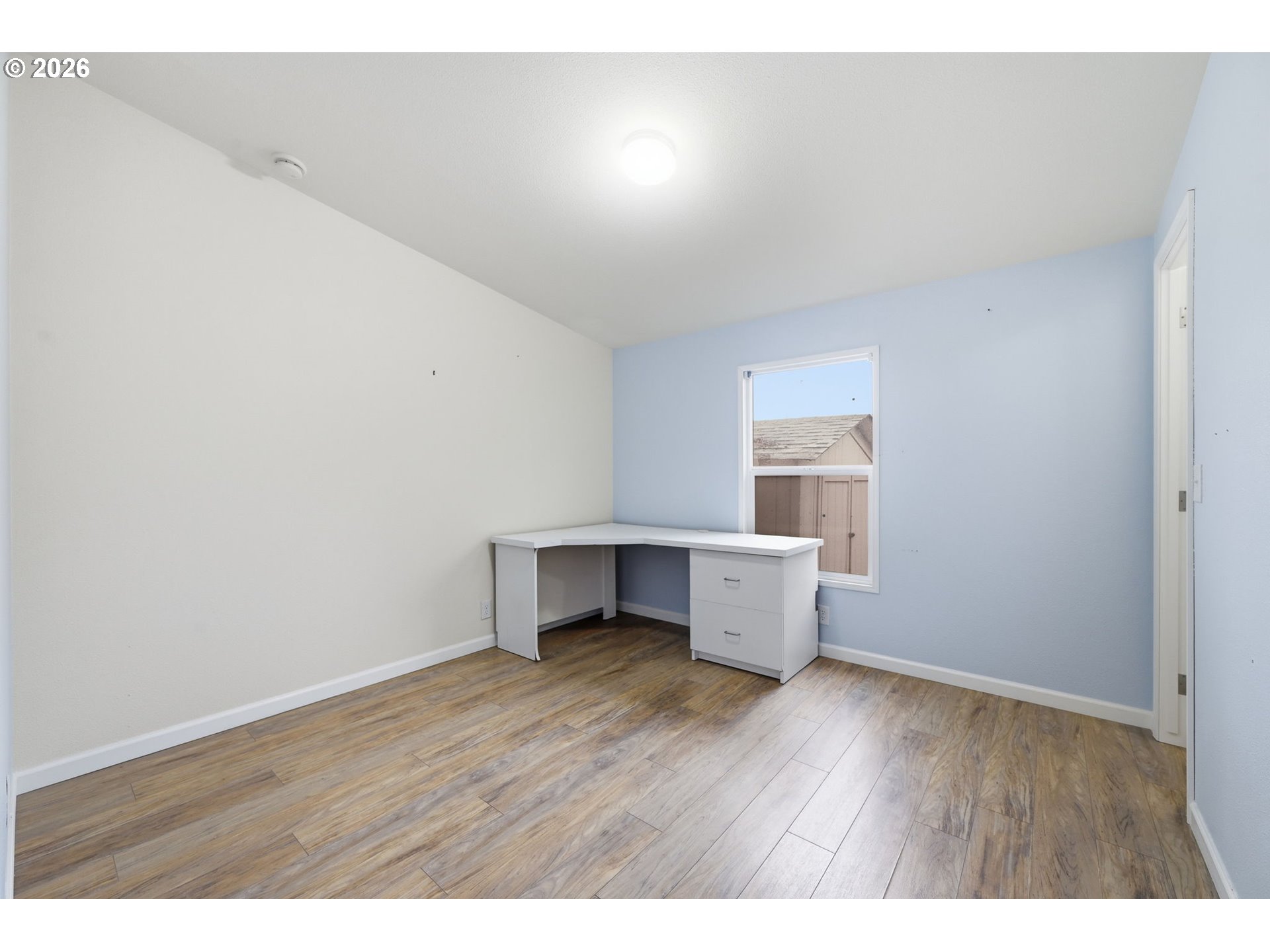 1475 Green Acres Road, Unit 150 Eugene, OR 97408 - Photo 20 of 34 a room with wooden floor and window