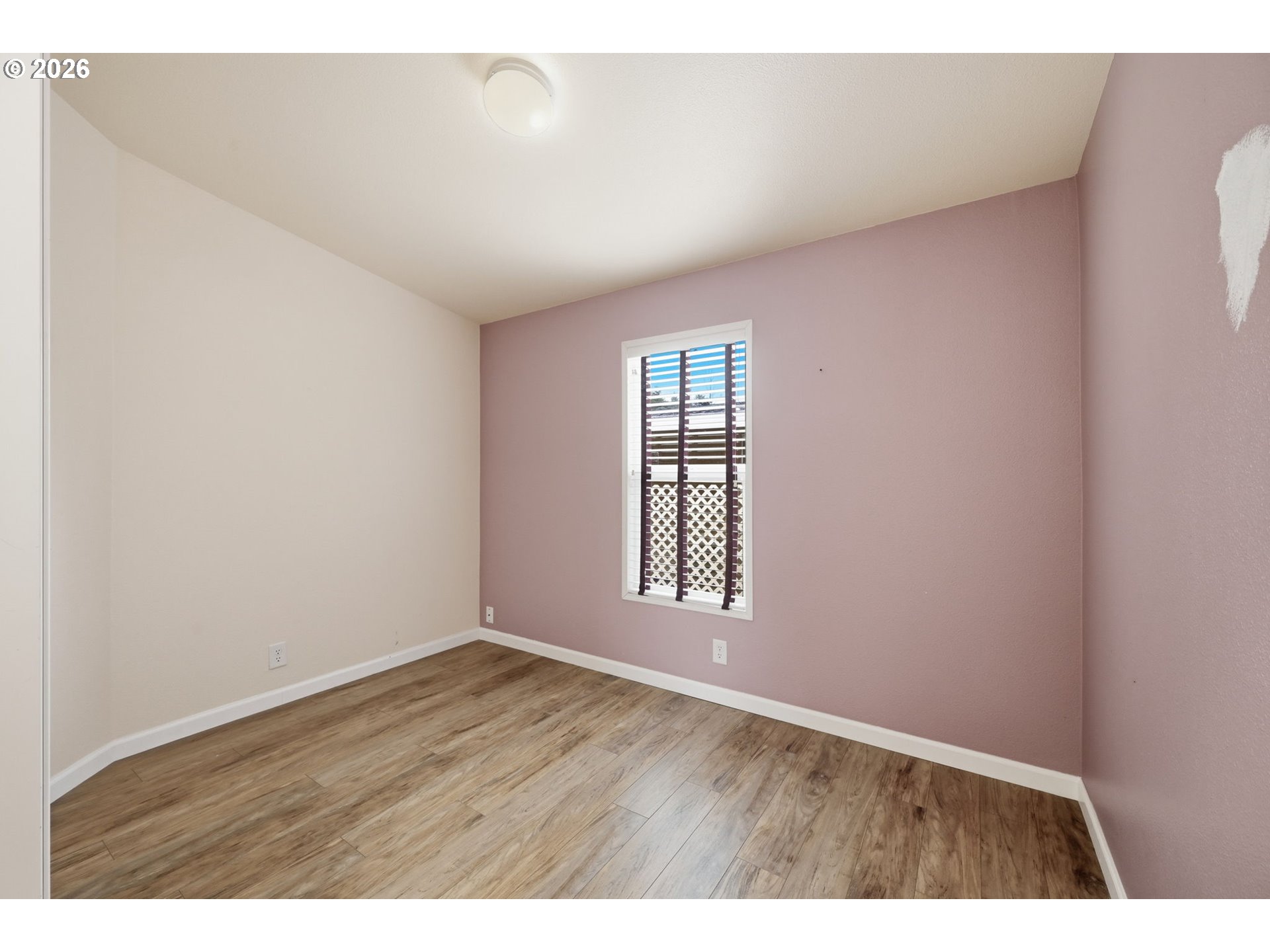 1475 Green Acres Road, Unit 150 Eugene, OR 97408 - Photo 22 of 34 a view of an empty room with wooden floor and a window