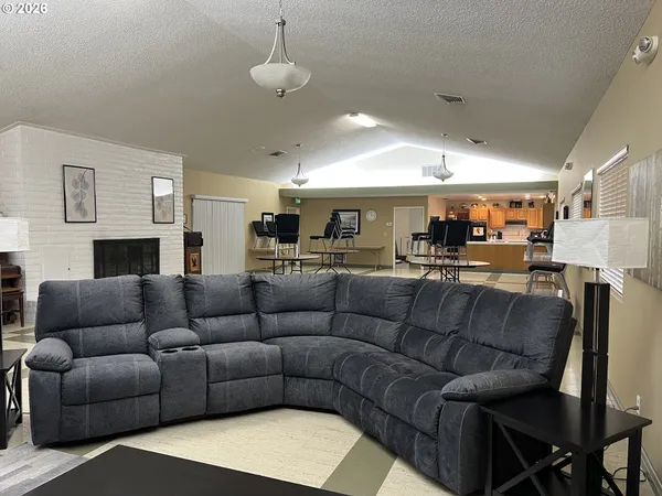 a living room with furniture kitchen and a chandelier